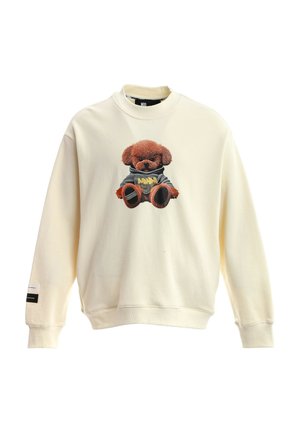 Sudadera color crema con un oso de peluche con una sudadera con capucha gris impreso en el frente, mangas largas y puños y bajo acanalados.