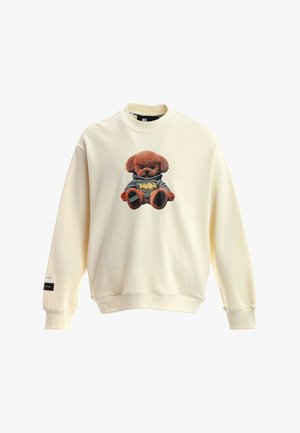 Sudadera color crema con un oso de peluche con una sudadera con capucha gris impreso en el frente, mangas largas y puños y bajo acanalados.