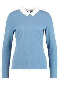 Långärmad skjorta i ljusblått med vit krage. Tillverkad av strukturerad tyg, med en enkel, figurnära design och släta sömmar.