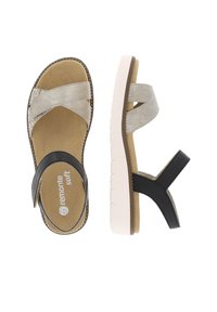 Sandales grises et noires avec des brides en tissu doux, une semelle intérieure texturée et une épaisse semelle blanche. Présentent des accents cousus et un détail de logo.