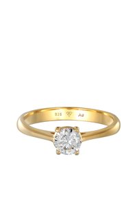 Vergulde sterling zilveren ring met een ronde, duidelijke edelsteen die in zes klauwen is gezet, met een gladde, gepolijste textuur en gegraveerde details aan de binnenkant van de ring.