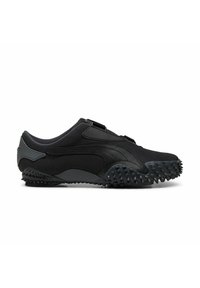 Chaussure de sport noire avec une tige en tissu texturé, un design épuré et une semelle en caoutchouc dotée de petites protubérances pour une meilleure adhérence. Fermeture avec une sangle ajustable.