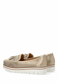 Zapatos slip-on metálicos dorados con diseño perforado, acento de lazo y una suela blanca texturizada con un detalle de raya roja.