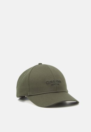 Olivgrüne Baseballkappe mit gebogenem Schirm und schwarzem Calvin Klein New York Logo vorn aufgestickt.