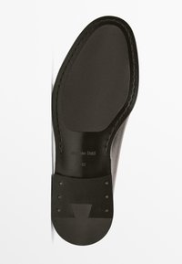 Leather shoe sole, black color, flat design, featuring stitching around the edge, branded with "Massimo Dutti" and size "42."