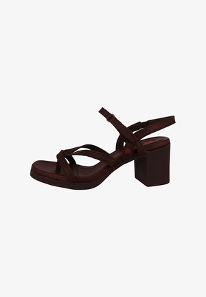 Brown suede heeled sandals with multiple cross straps, a square block heel, and a flat sole. Classic design suitable for various occasions.