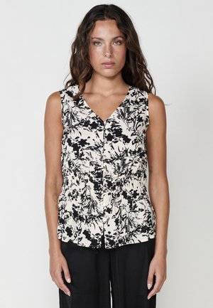 Sleeveless blouse in cream fabric with a black floral print. Features a V-neckline, button-down front, and gathered waist detail.