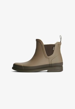 Bruna gummistövlar till anklarna med en slät yta, utrustade med en texturerad elastisk panel, vit fuskpälsfoder och en ögla för att dra i stöveln.