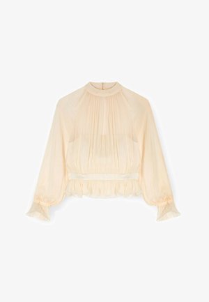 Bluzka z krótkim rękawem w kremowym kolorze, wykonana z lekkiego materiału. Posiada plisowany design, wysoki kołnierz oraz marszczony dół z falbankowymi mankietami.