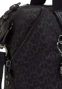Black nylon backpack featuring a geometric pattern, zipper closure, leather accents, and metal hardware details. Textured surface adds depth.
