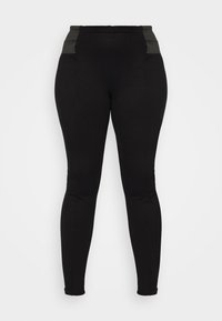 Leggings noirs taille haute avec une ceinture élastique texturée et une coupe élégante. Présente des accents gris angulaires au niveau de la ceinture.