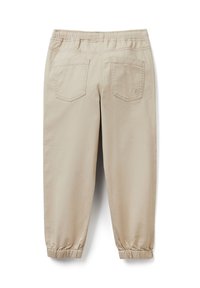 Béžové kalhoty s elastickým pasem, dvěma zadními kapsami a elastickými lemy, zobrazené zezadu na bílém pozadí.