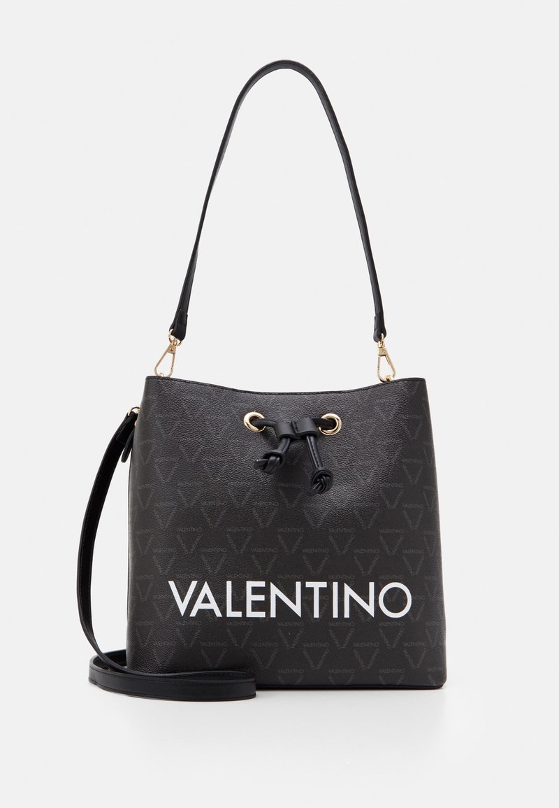 Black bucket bag with gold-tone hardware, textured synthetic material, and textured triangular pattern. Features a large white "VALENTINO" logo.