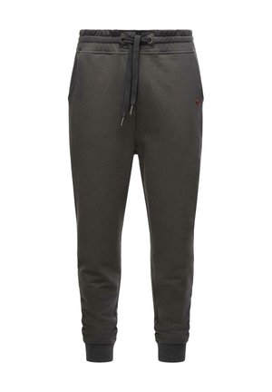 Dark green sweatpants made of soft fabric, featuring an adjustable waistband with drawstrings, side pockets, and ribbed cuffs.