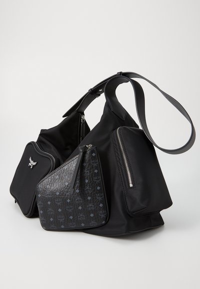 Black nylon handbag with multiple compartments. Features textured black leather accents with patterned detailing and silver hardware.