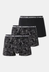 Set von drei schwarzen Boxershorts mit einem schlichten Design und einem grafischen Muster mit weißen Schriftzügen. Elastischer Bund mit Logodetail.