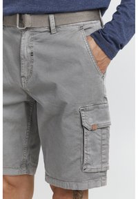 Gray cargo shorts with a pocket on the side, cotton fabric, visible stitching, and a woven beige belt. Features casual styling and a relaxed fit.