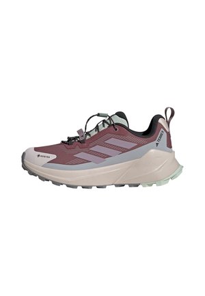 Buty do biegania terenowego w kolorach fioletowo-szarym z grubą białą podeszwą, czarną wyściółką, pętelką na pięcie oraz elastycznym sznurowaniem z zaciskem.