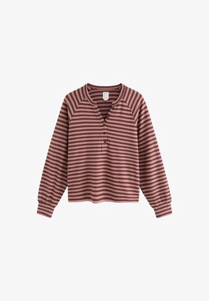 Haut à manches longues rayé en rose poussiéreux et mauve, avec un décolleté en V ornée de quatre boutons, des manches raglan et des poignets élastiques. Texture de tissu douce.