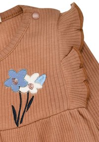 Brown ribbed fabric top featuring three embroidered flowers: blue, white, and light blue; includes ruffled sleeve edges and a button detail.