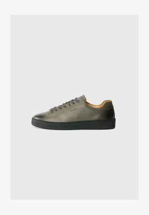 Sneakers in olive green leather with black rubber sole. Features round toe, tonal laces, and minimalistic design. Inside lined with tan material.