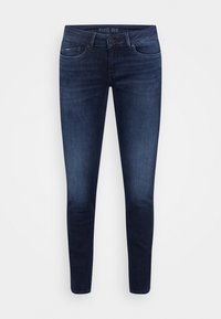 Jeans slim fit blu scuro con chiusura a bottoni e zip, tasche anteriori e posteriori, e un leggero sbiadimento sulle cosce e sulle ginocchia.