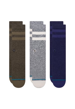 Three pairs of socks: dark brown with stripes, gray with white stripes, and navy, all featuring a soft texture and colored accents.