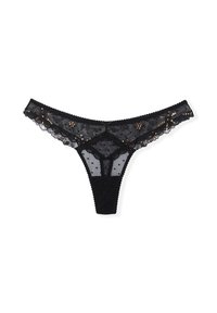 Tanga de encaje negro con detalles florales, patrón de lunares y pequeñas lentejuelas. Bordes con ondas y una cinturilla de tejido suave.