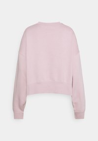 Jasnoróżowy skrócony sweatshirt z okrągłym dekoltem, opadającymi ramionami i ściągaczami. Gładka tkanina z minimalnymi szczegółami wzorniczymi.