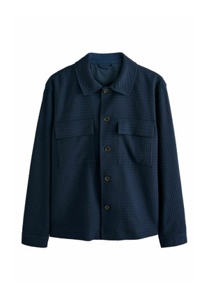 Tengerészkék mintás hosszú ujjú ingdzseki gallérral, gombos elülső záródással és két mellkasi zsebbel.