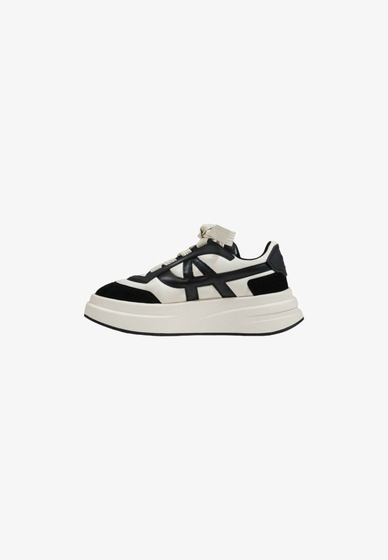 Black and white sneaker featuring a chunky sole, smooth leather and suede texture, with prominent laces and a logo detail on the side.