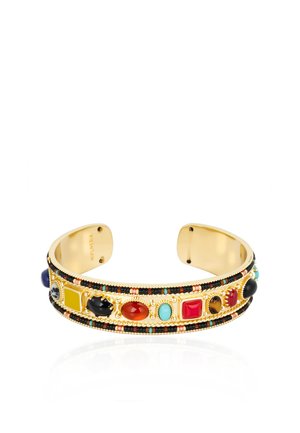 Gold cuff bracelet with colorful oval and square stones in red, turquoise, black, yellow, and brown, adorned with small black and gold beads.