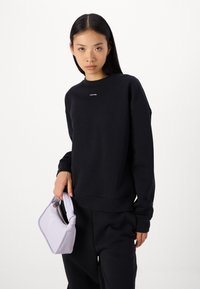 Calvin Klein NANO LOGO  - Treniņtērpa apakšdaļas - black
