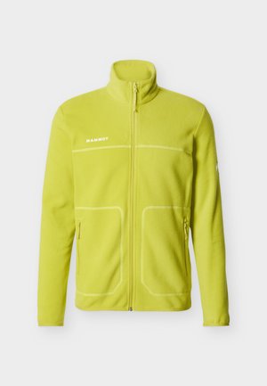 Chaqueta de forro polar de color amarillo-verde brillante con cremallera frontal completa, dos bolsillos laterales con cremallera, cuello alto y logo blanco de "Mammut" en el pecho.