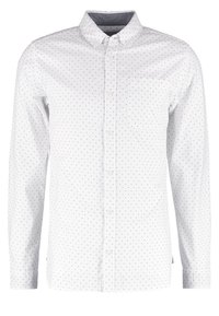 Bílá košile s dlouhým rukávem a límečkem na knoflíky, zdobená jemným černým diamantovým vzorem, s přední kapsou a klasickým zapínáním na knoflíky.