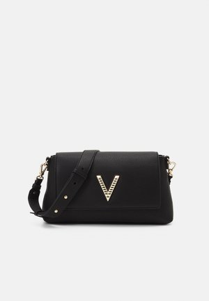 Black leather handbag with a structured design, featuring a gold V-shaped accent and a detachable shoulder strap. Textured finish.