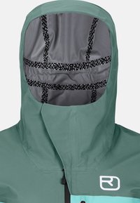 Green and teal hooded jacket featuring a smooth texture, adjustable hood with patterned lining, and front zipper closure.
