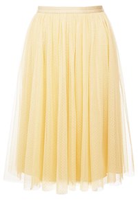 Gonna di tulle gialla con vita aderente. Il design presenta una silhouette a strati e svasata, con piccoli punti testurizzati in tutto il capo.