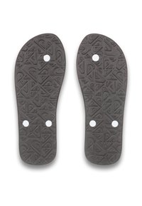 Semelles intérieures noires en caoutchouc présentant un motif géométrique, avec trois trous circulaires blancs pour l'alignement ou le maintien, conçues pour le confort et l'adhérence.