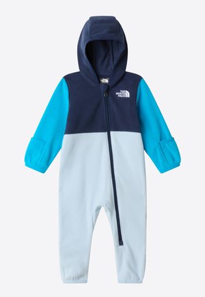 Fleece one-piece suit in navy and light blue. Features a zip front, hood, and elasticized cuffs. Logo on the chest. Soft texture.