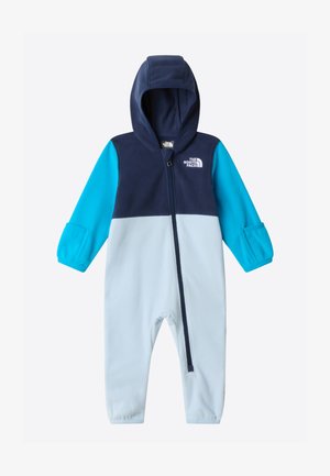 Jednodijelno odijelo od flisa u mornarsko plavoj i svijetloplavoj boji. Ima patentni zatvarač sprijeda, kapuljaču i elastične manžete. Logo na prsima. Mekana tekstura.