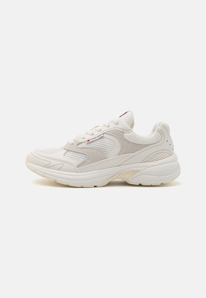 Hvite og beige sneakers med meshnettpaneler, detaljer i semsket skinn, tykk såle, snøring og en subtil Tommy Jeans-logo på siden.