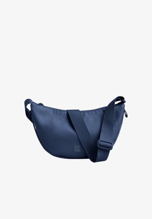 Navy blue shoulder bag made of durable fabric, featuring a curved shape, adjustable strap, and a reinforced zipper closure.