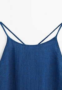 Camisole en lin bleu à fines bretelles, avec une silhouette décontractée et une texture douce, idéale pour les temps chauds.