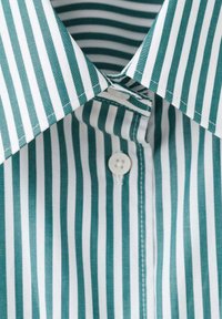 Green and white striped shirt with a button closure, featuring a spread collar and smooth fabric texture. Stripes are evenly spaced.