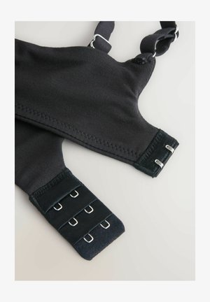 Schwarzer BH mit verstellbaren Trägern, strukturiertem Stoff und Metallhakenverschluss. Verfügt über glatte Nähte und eine strukturierte Form.