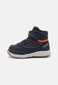 Navy blue children's sneakers with a padded collar, white sole, orange accent, and adjustable Velcro strap. Features stitching details and rubber outsole.