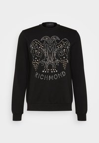 Svart sweatshirt med en dekorativ design med metallspikar, långa ärmar och rund halsringning. "Richmond" är tryckt längst ner.