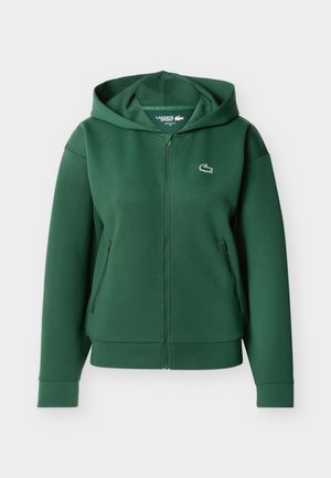 Dark green zip-up hooded sweatshirt with two zip pockets and a small crocodile logo on the left chest.