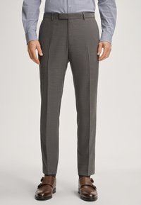 Gray dress pants with a textured fabric, featuring a flat front, two pleats, and side pockets, paired with brown buckle shoes.